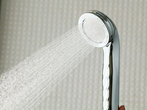 Eine Duschbrause, aus der Wasser fließt.