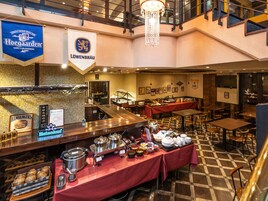 A buffet setup with various food stations, a bar area, and seating arrangements.
