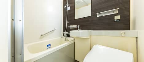 A bathroom with a bathtub, sink, and toilet.
