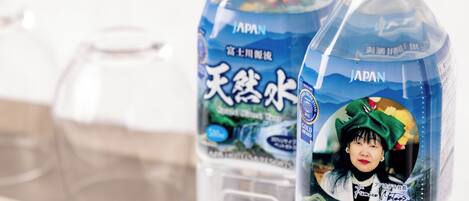 Two bottles of water with labels, one with a gold award and the other with a blue label.