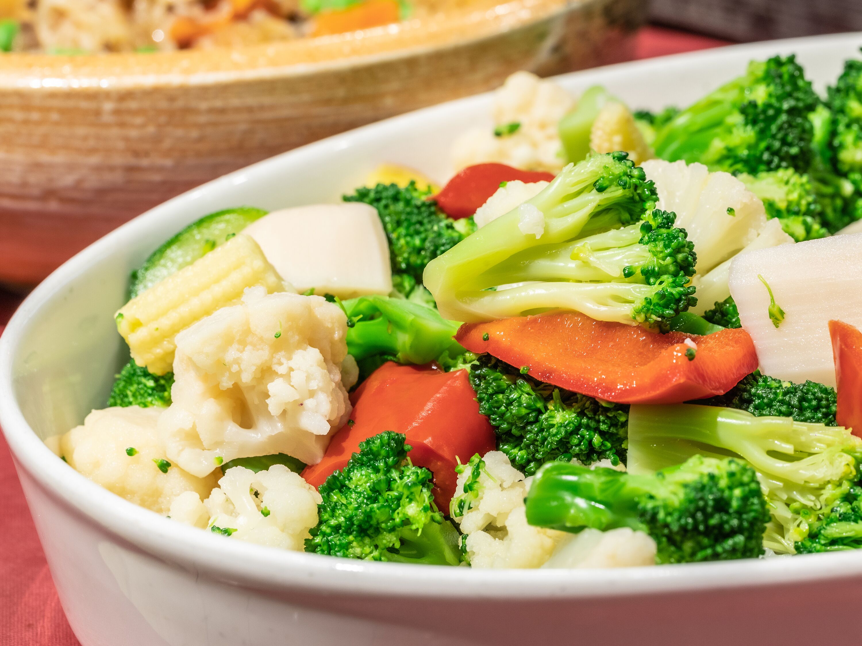 A bowl of mixed vegetables including broccoli, cauliflower, and carrots.