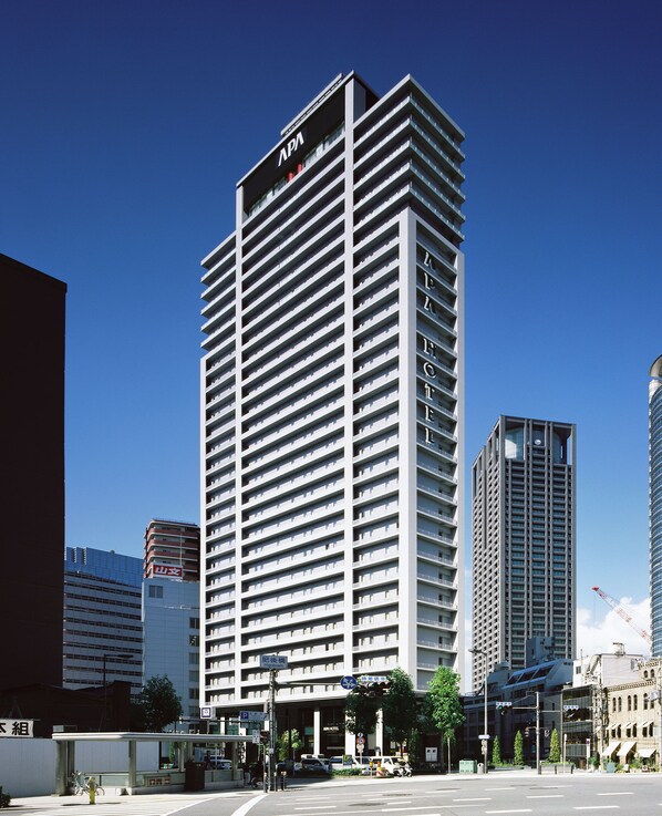 A high-rise hotel with a modern architectural design, featuring a prominent 'APA' sign at the top. - APA Hotel Osaka Higobashi Ekimae Tower (Osaka)