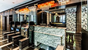 A modern hotel lobby with marble flooring, a reception desk, and a chandelier. - APA Hotel Yodoyabashi Ekimae (Osaka)