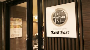 A restaurant sign with "Kent East" and "RESTAURANT & CAFE" text, a menu, and a door with a reflection. - APA Hotel Yodoyabashi Ekimae (Osaka)