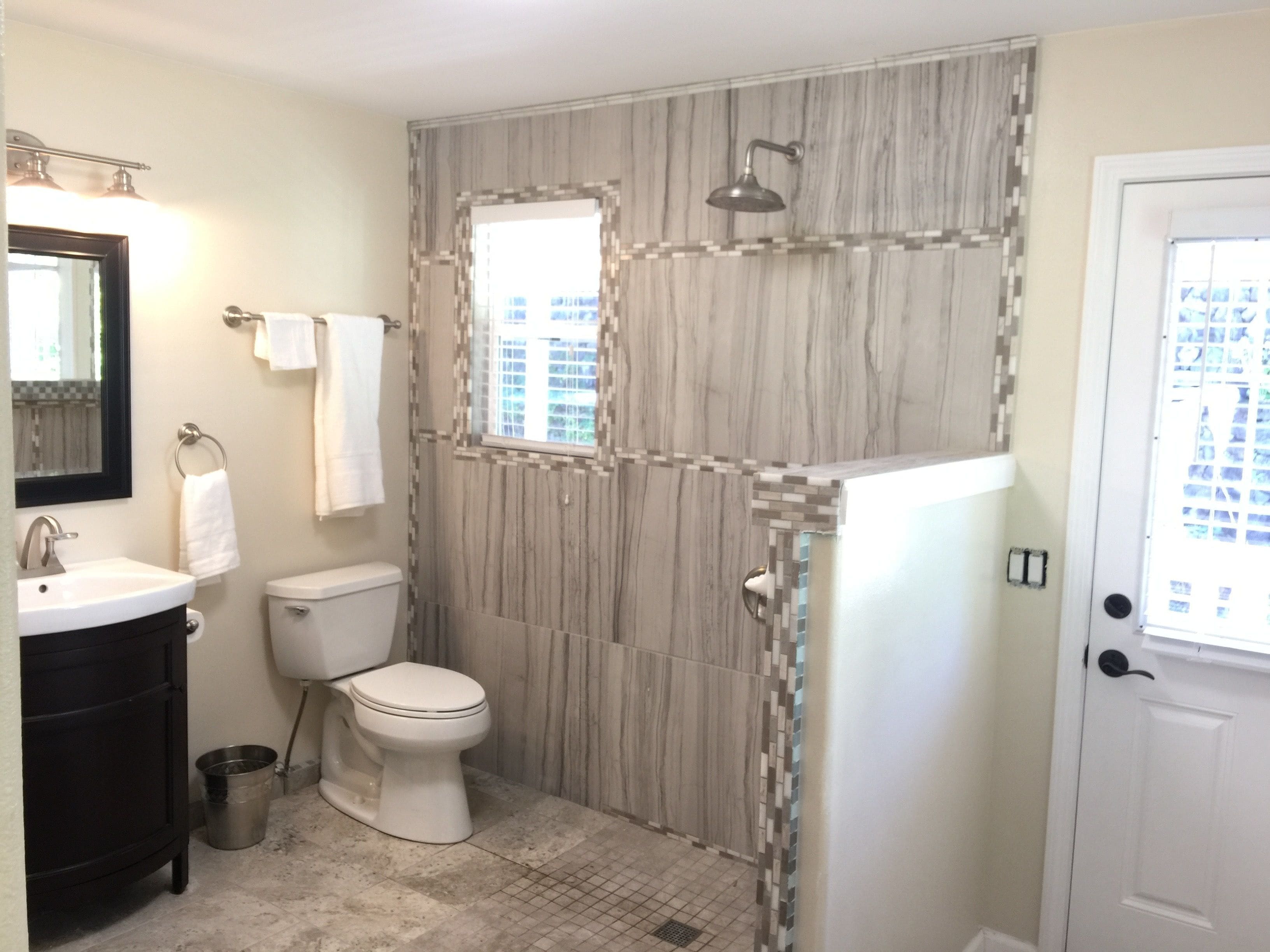 A bathroom with a toilet, sink, and shower.