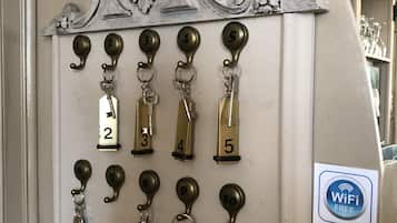 A wall-mounted key rack with numbered keys and a WiFi sign indicating free WiFi access.