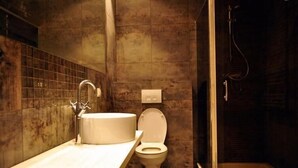 A bathroom with a sink, toilet, and shower.