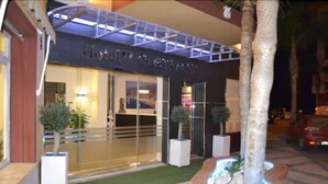 The exterior of Hotel Costamar with a modern facade, large glass windows, and a well-lit entrance. - Hotel Costamar (Torrox)