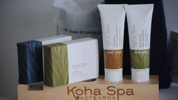 A display of Kohha Spa products including a soothing hair conditioner, nourishing hair shampoo, and a luxury vanity kit.