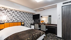 A hotel room with a large bed, a desk with a chair, a television, and a wardrobe. - APA Hotel Sapporo Hosui Susukino Ekimae (Sapporo)