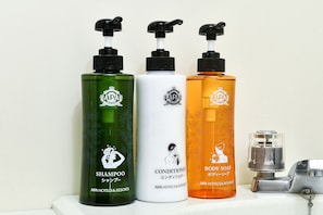 Three bottles of shampoo, conditioner, and body soap on a shelf. - APA Hotel Sapporo Hosui Susukino Ekimae (Sapporo)