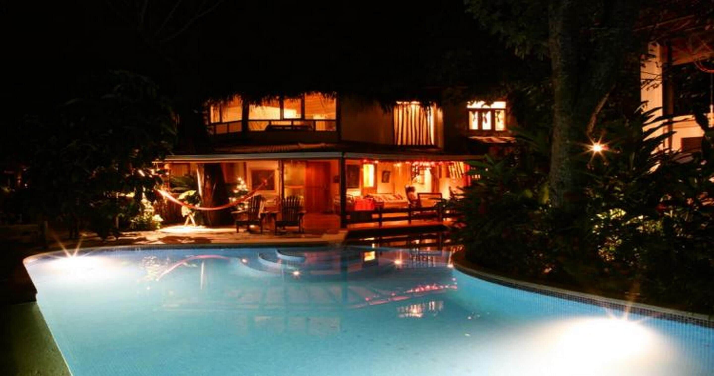 A two-story building with a swimming pool in front.