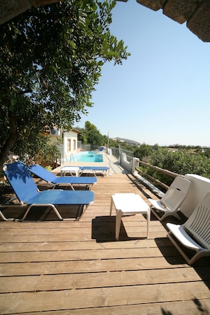 Outdoor pool, an infinity pool, pool umbrellas, sun loungers