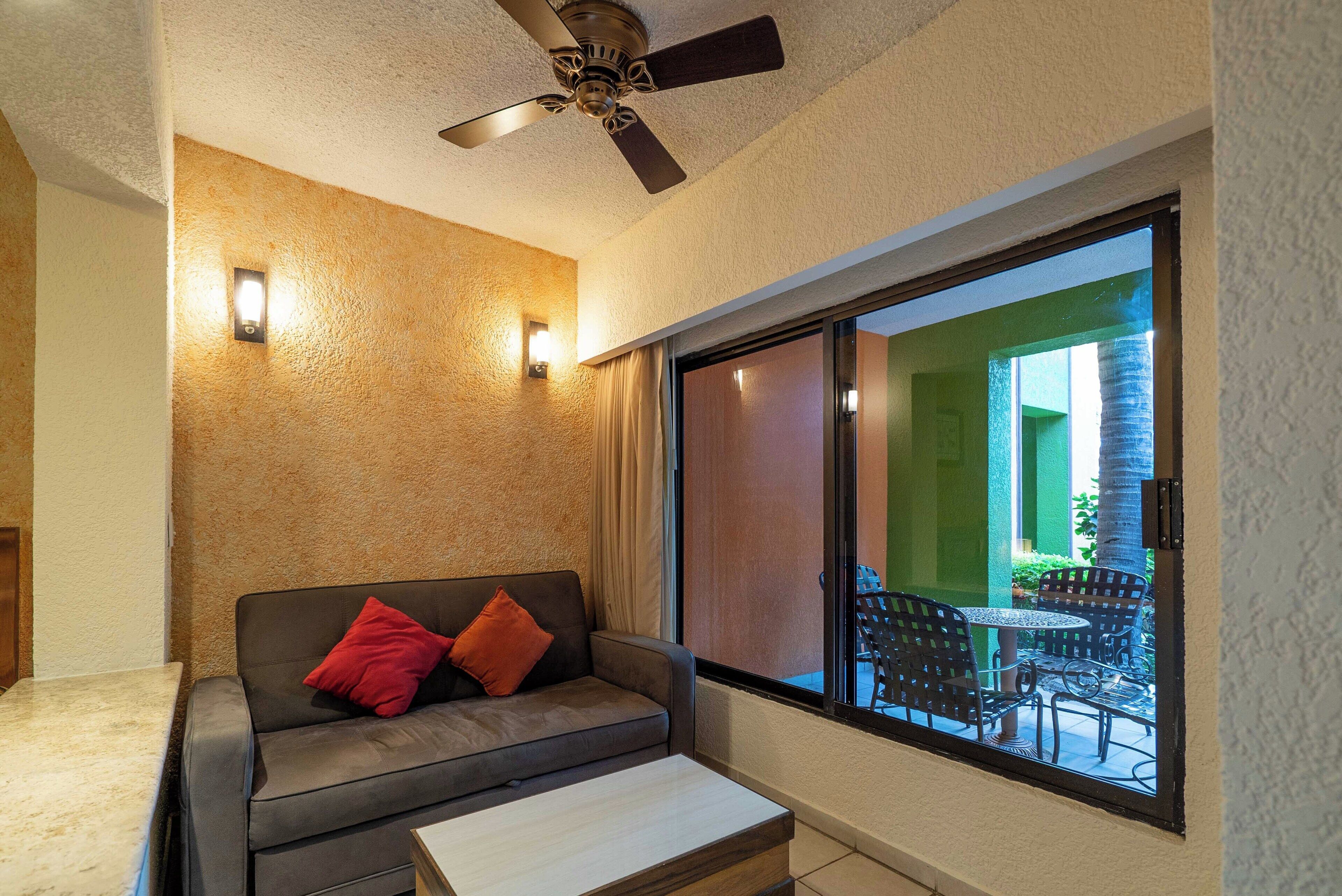 standard room, garden view, sea facing | living area | tv