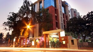 A modern building with multiple floors, large windows, and a well-lit entrance. - Keys Select by Lemon Tree Hotels, Nestor, Mumbai (Mumbai)