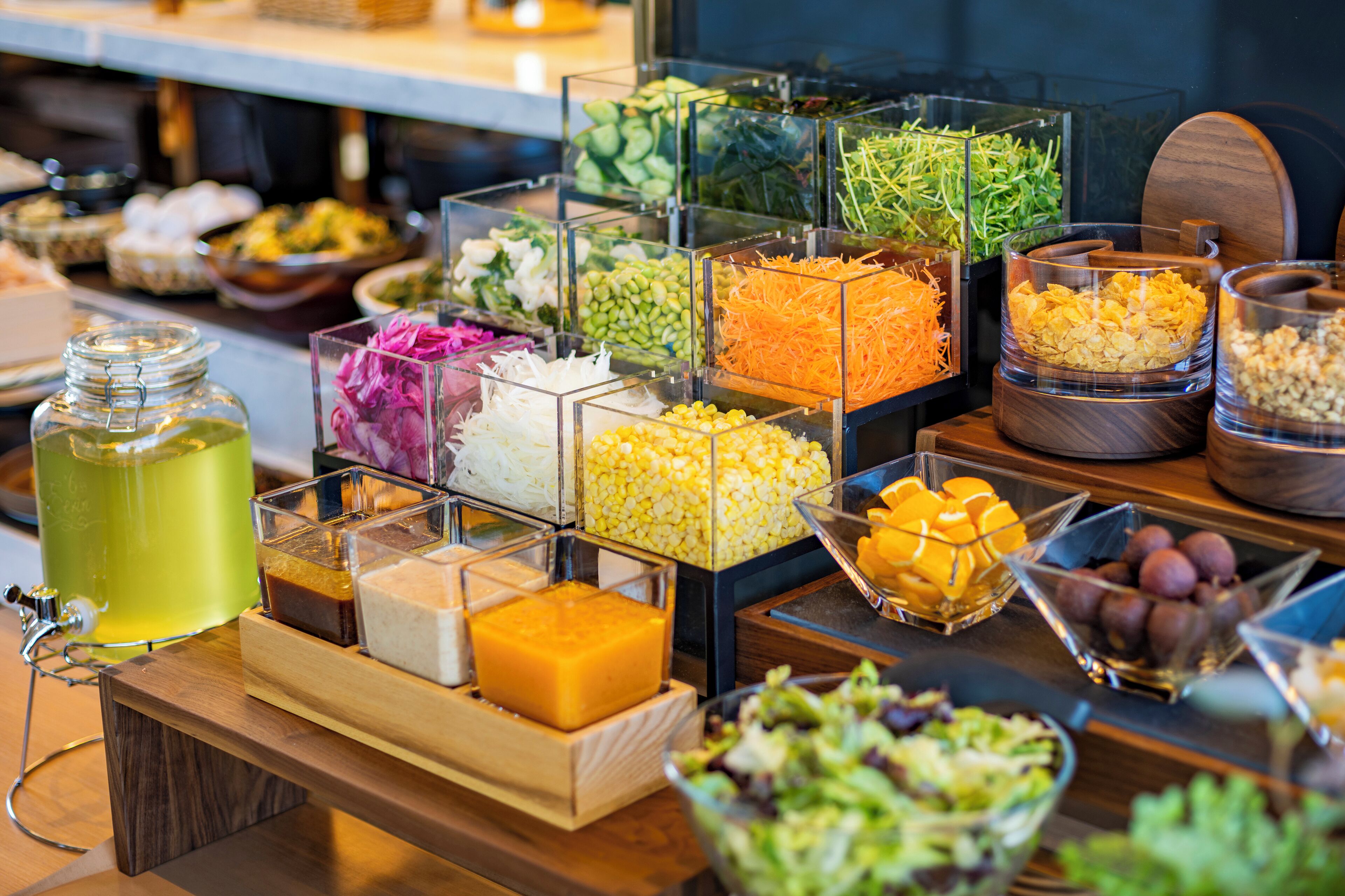 A buffet with various food items in clear containers.