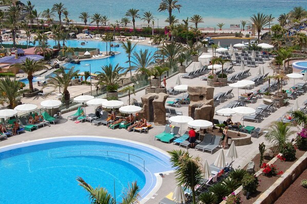 Indoor pool, outdoor pool, pool umbrellas, pool loungers