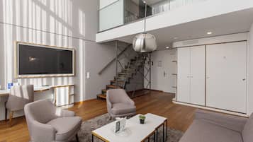 Deluxe Suite | Living area | Flat-screen TV, toys