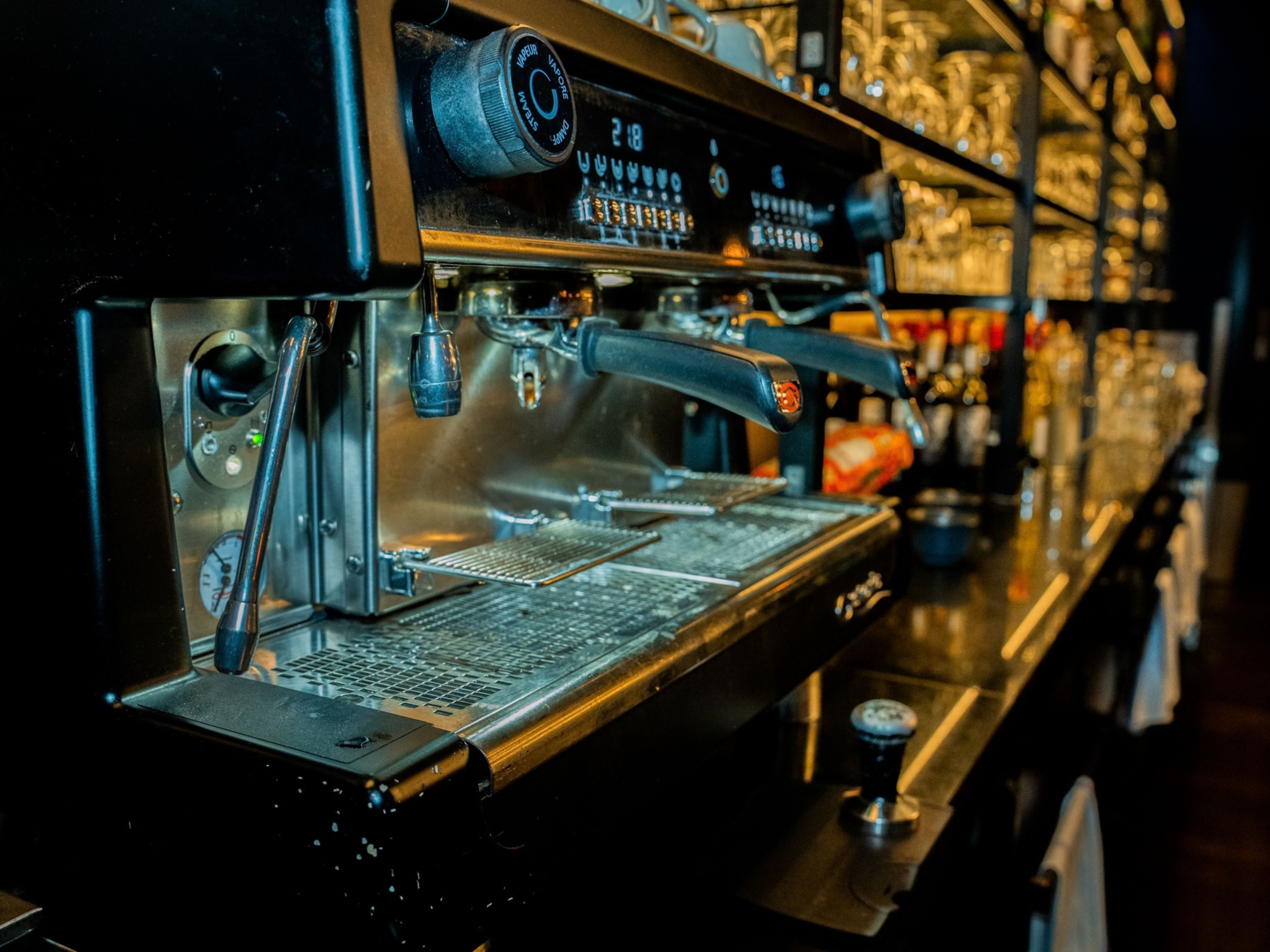 A coffee machine with a digital display and steam wand.