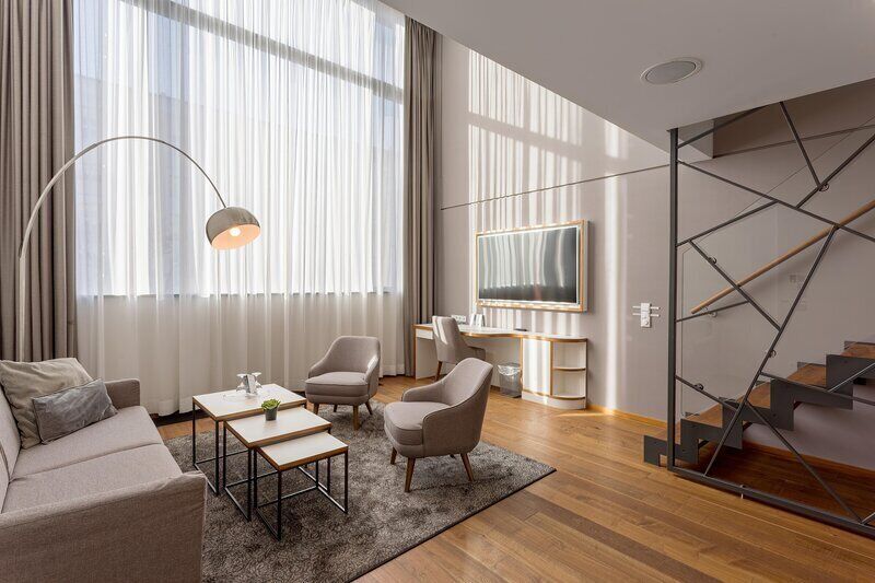 Deluxe Suite | Living area | Flat-screen TV, toys