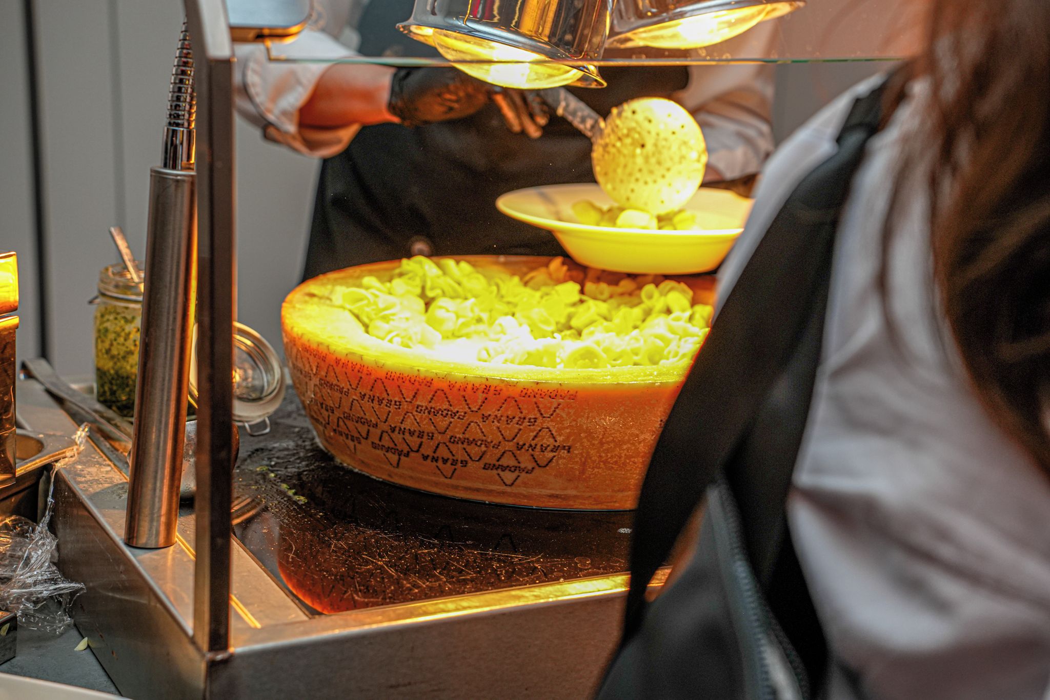 A buffet setup with a large serving dish and a bowl of food.