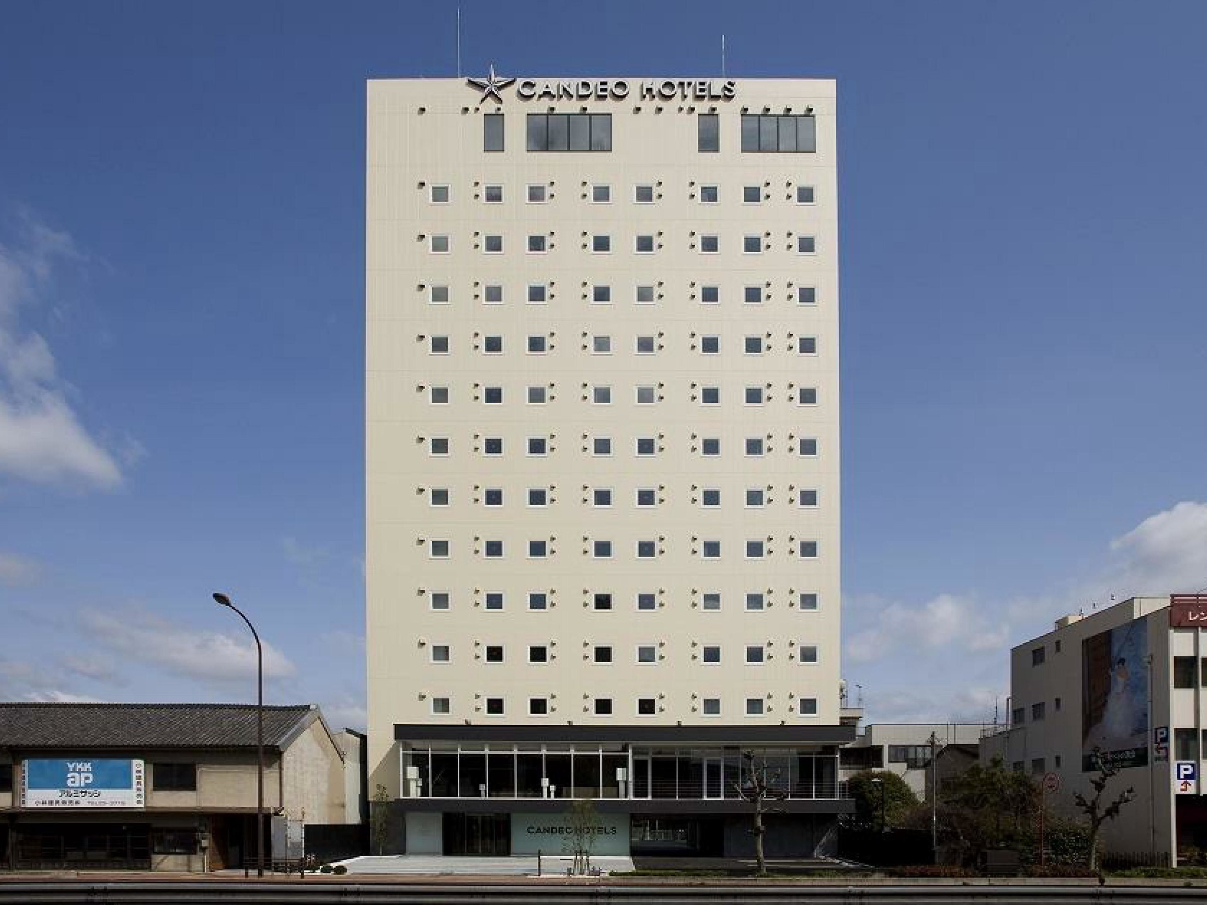 A tall, modern hotel building with a flat facade and numerous windows.