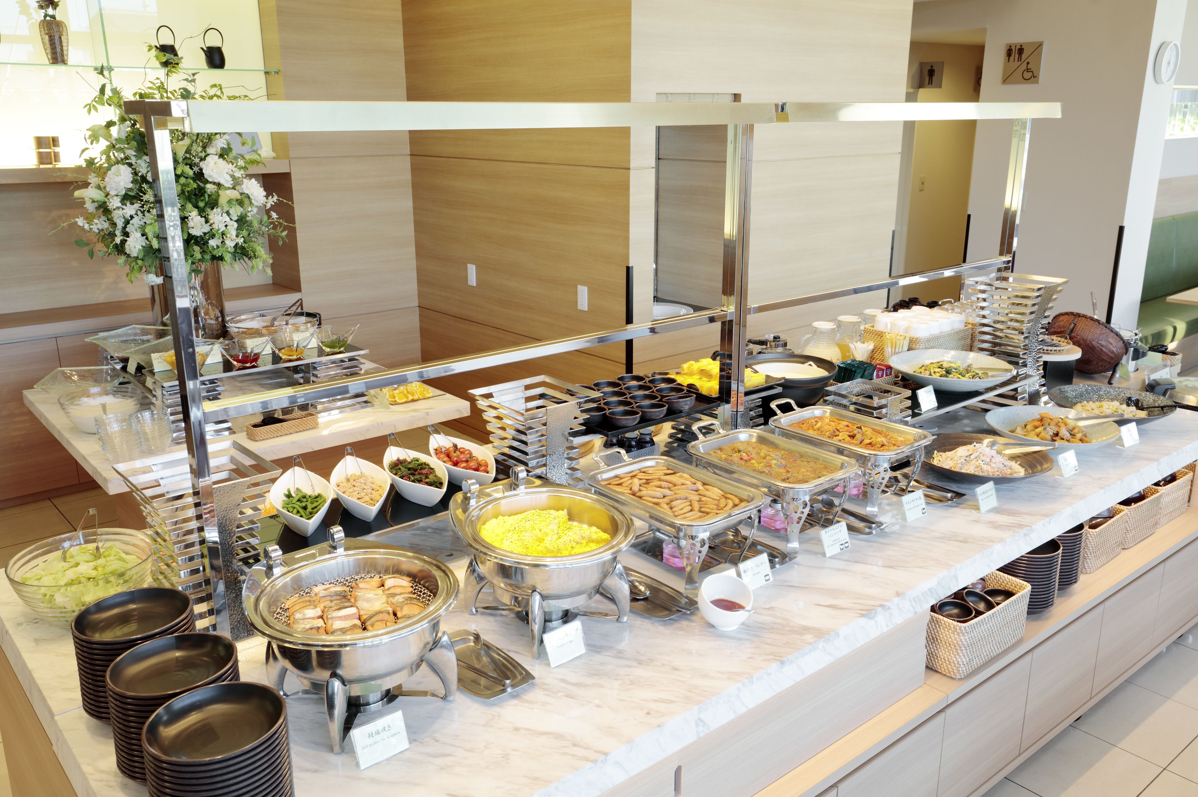 A buffet with various food items and serving utensils.