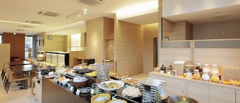 A buffet area with various food items and beverages.