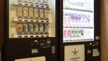 Two vending machines with a variety of beverages and snacks, both branded with "CANDEO HOTELS".