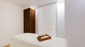 Relax in a stylishly designed room with a comfortable bed, a wooden wardrobe, and a decorative partition.