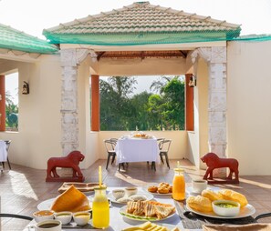 Dine al fresco amidst lush greenery in a serene outdoor setting.