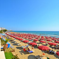 Relax on the beach with ocean views and comfortable sun loungers.