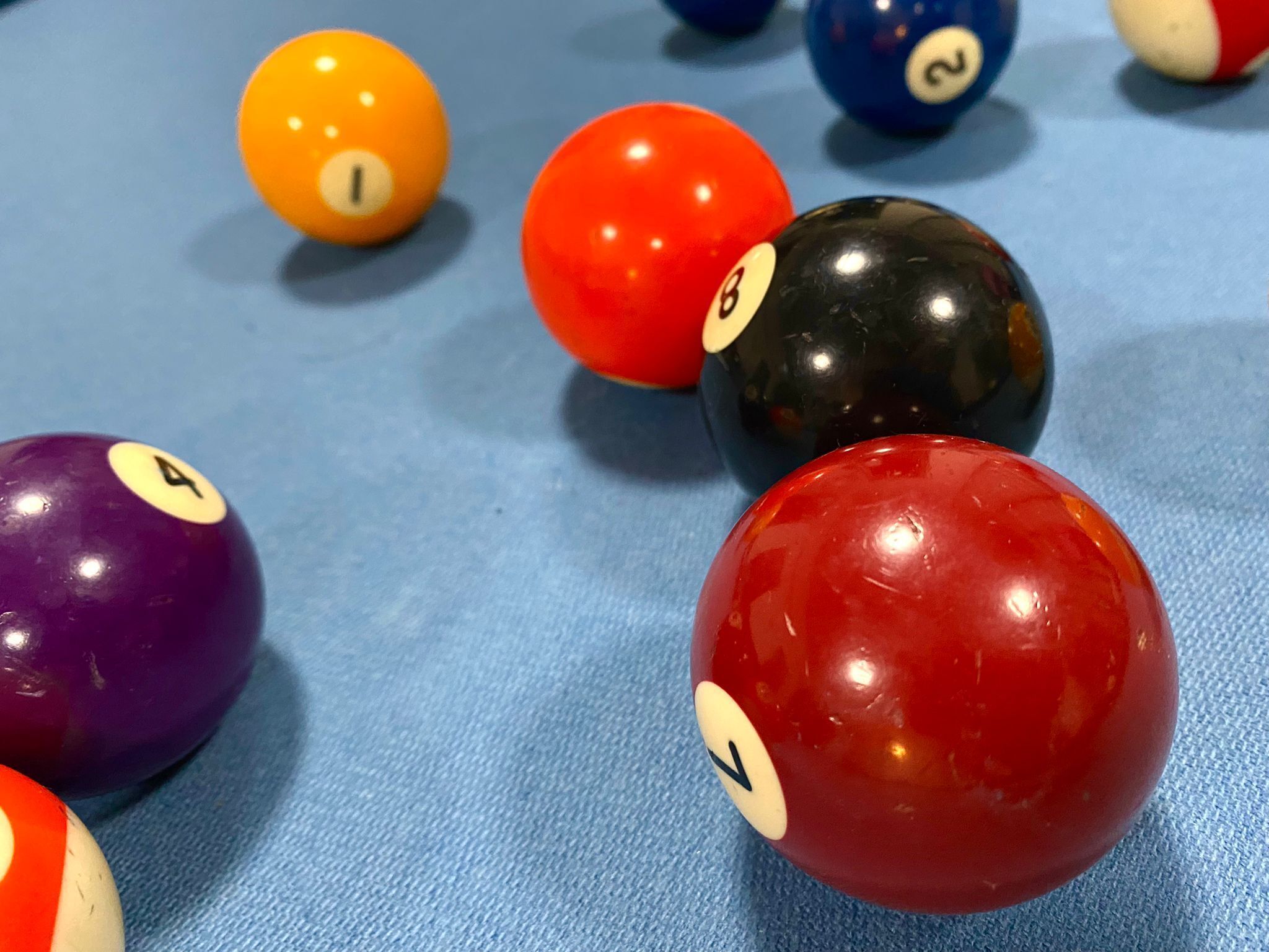 A pool table with various numbered billiard balls.