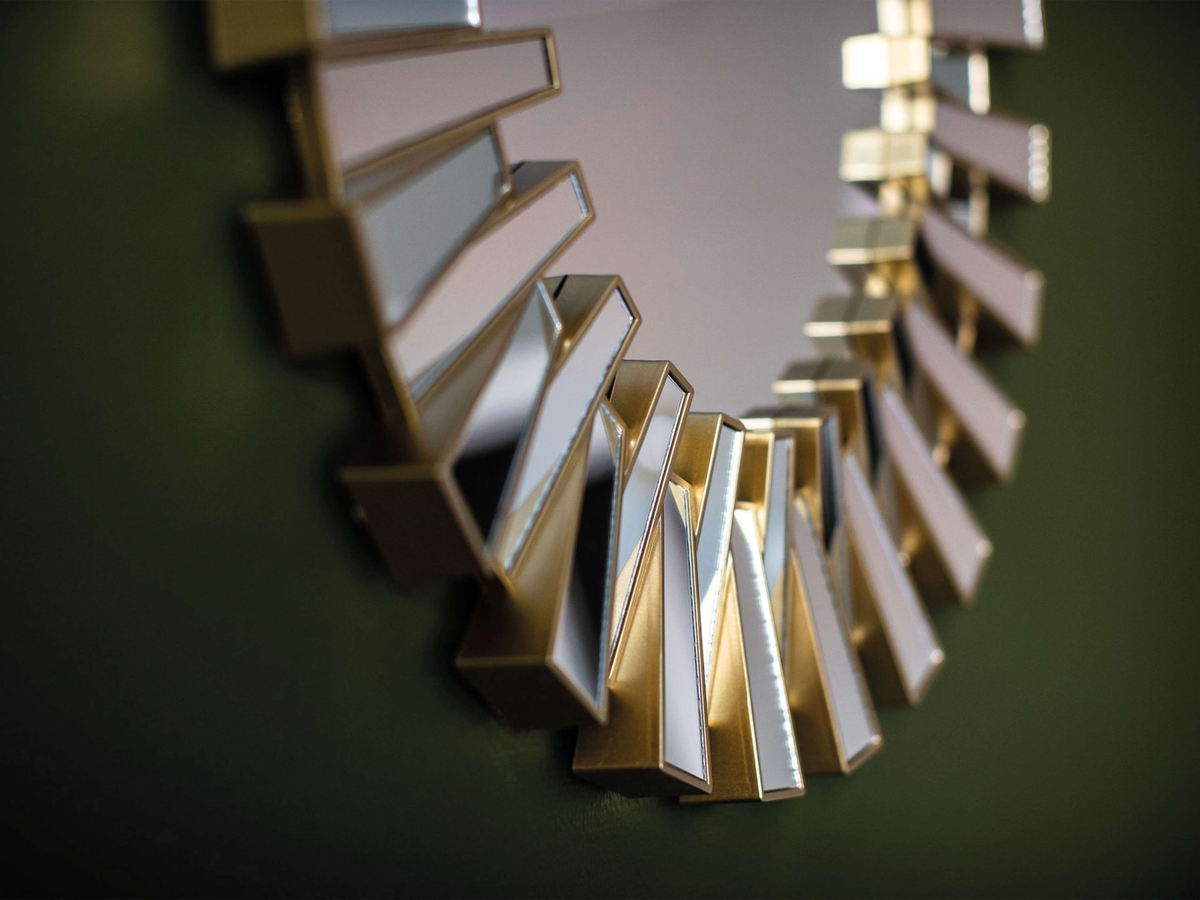 A close-up of a metallic, geometric wall art piece.