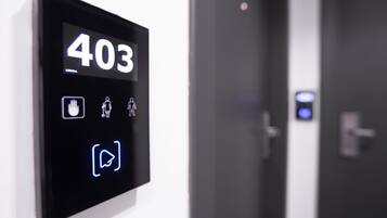 A digital display with the number 403 on a hotel room door, indicating room number.
