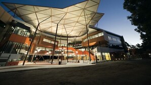 A modern building with a distinctive geometric roof structure, large glass windows, and a spacious entrance area. - Quest Campbelltown (Campbelltown)