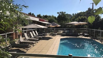 Outdoor pool, open 9:00 AM to 7:00 PM, pool umbrellas, pool loungers