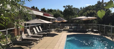 Outdoor pool, open 9:00 AM to 7:00 PM, pool umbrellas, pool loungers