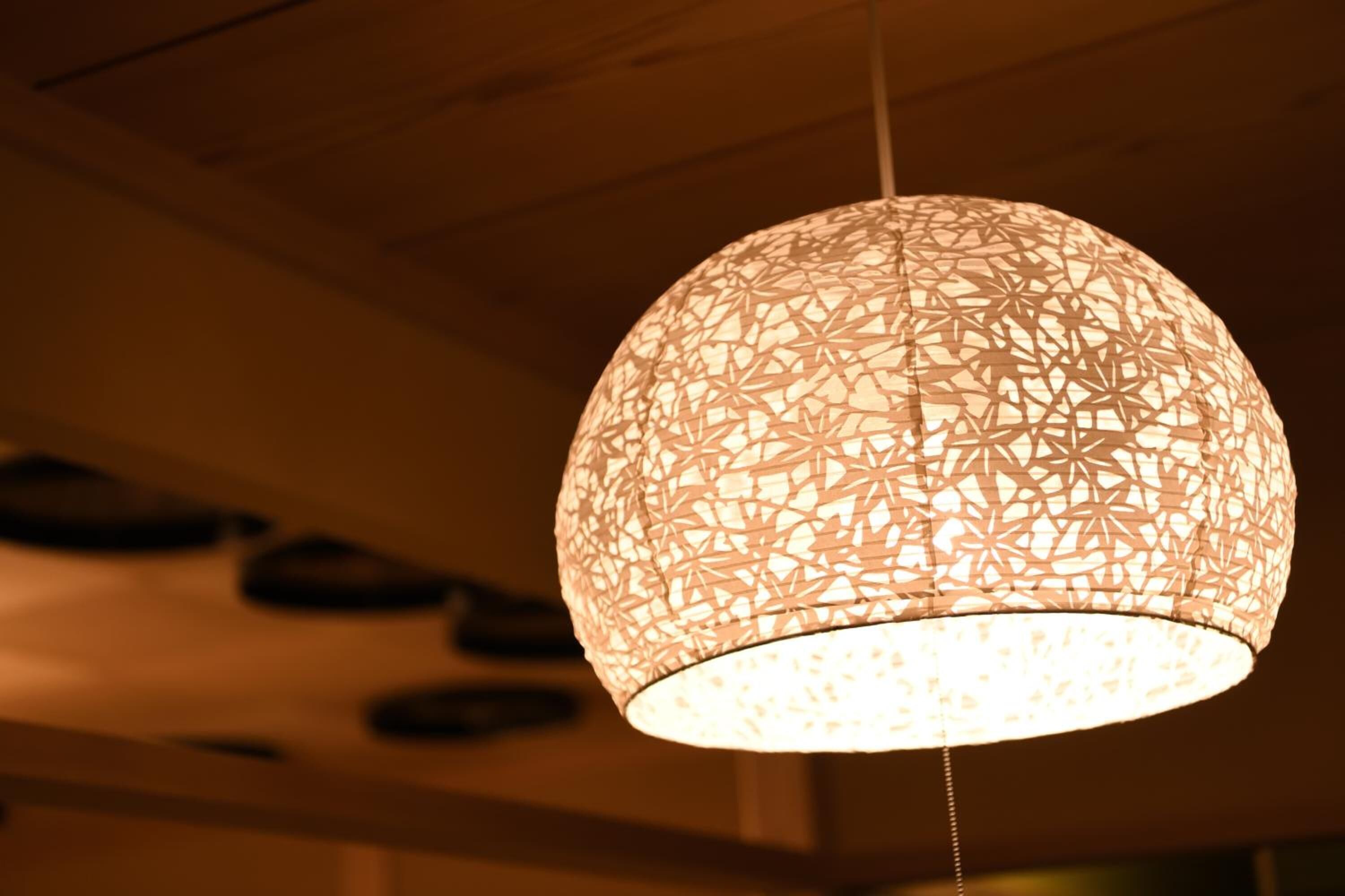 A hanging light fixture with a geometric pattern.
