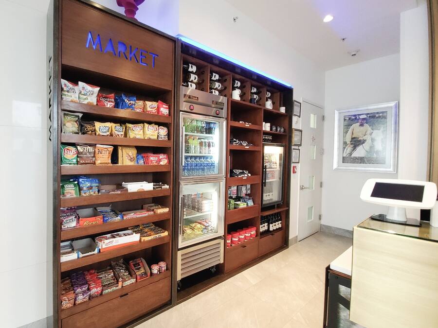A market area with shelves stocked with snacks and beverages.