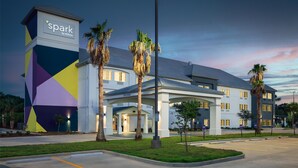 Un hotel de diseño moderno, con fachada geométrica y una entrada bien iluminada.