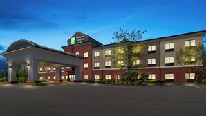 A Holiday Inn Express hotel with a brick facade, large windows, and a covered entrance. - Holiday Inn Express and Suites Fairmont by IHG (Fairmont)
