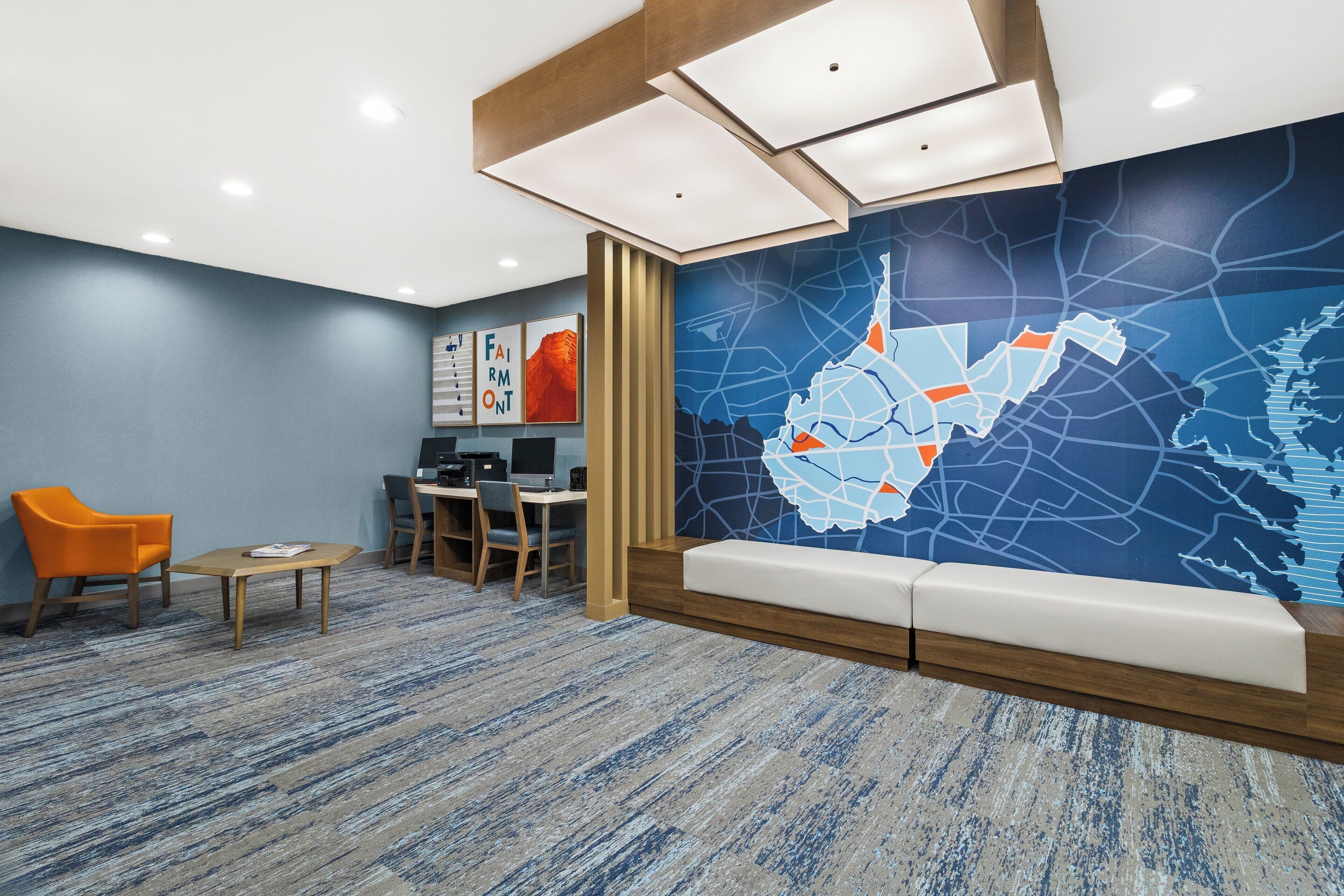 A modern reception area with a seating area, a desk, and a large wall map.