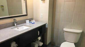 A bathroom with a sink, mirror, towel rack, and toilet. - Holiday Inn Express Havelock NW- New Bern by IHG (Havelock)