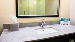 A bathroom with a sink, mirror, and toiletries. - Holiday Inn Express Havelock NW- New Bern by IHG (Havelock)
