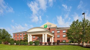 A Holiday Inn Express hotel with a brick facade, a covered entrance, and a well-maintained lawn.
