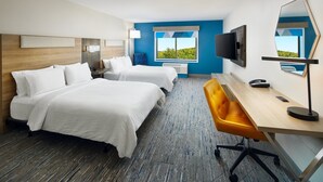 A hotel room with two beds, a desk, a chair, a TV, and a large window with a view.