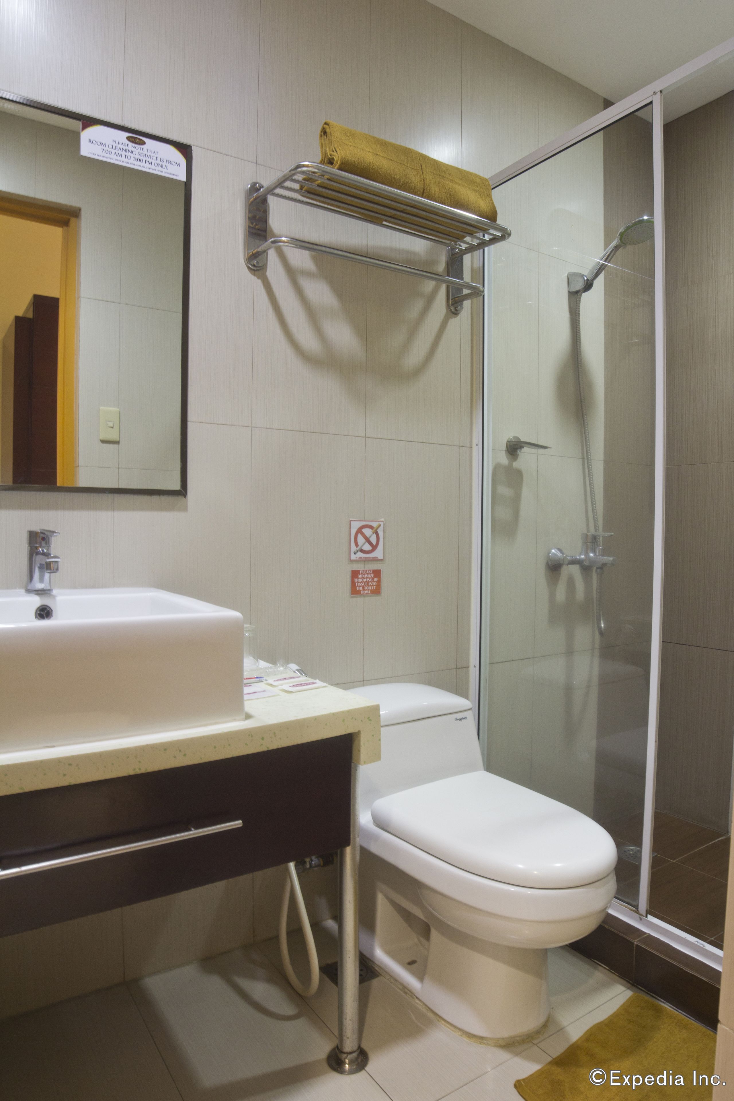 A bathroom with a sink, toilet, and glass-enclosed shower.