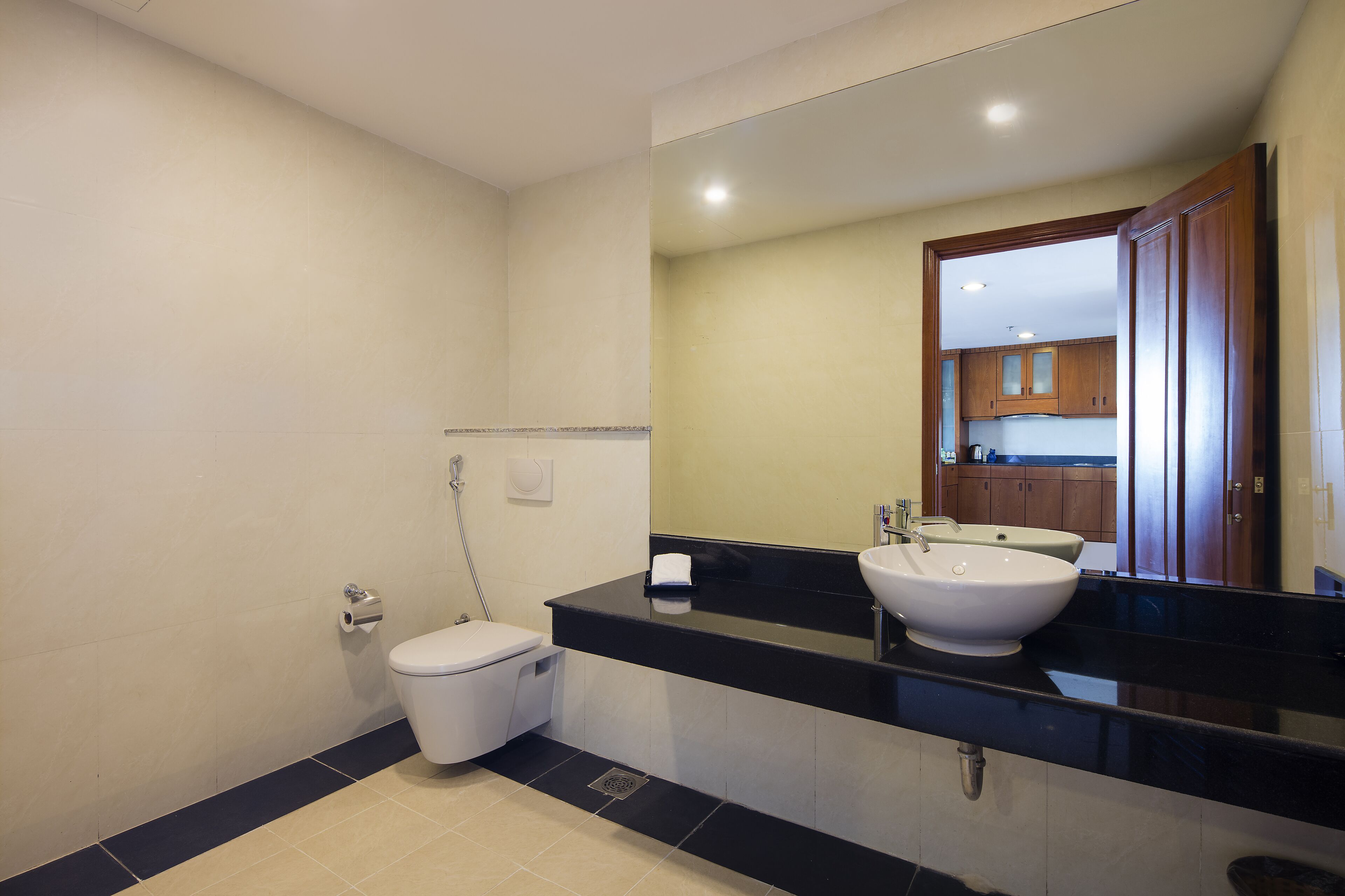 A bathroom with a toilet, sink, and mirror.