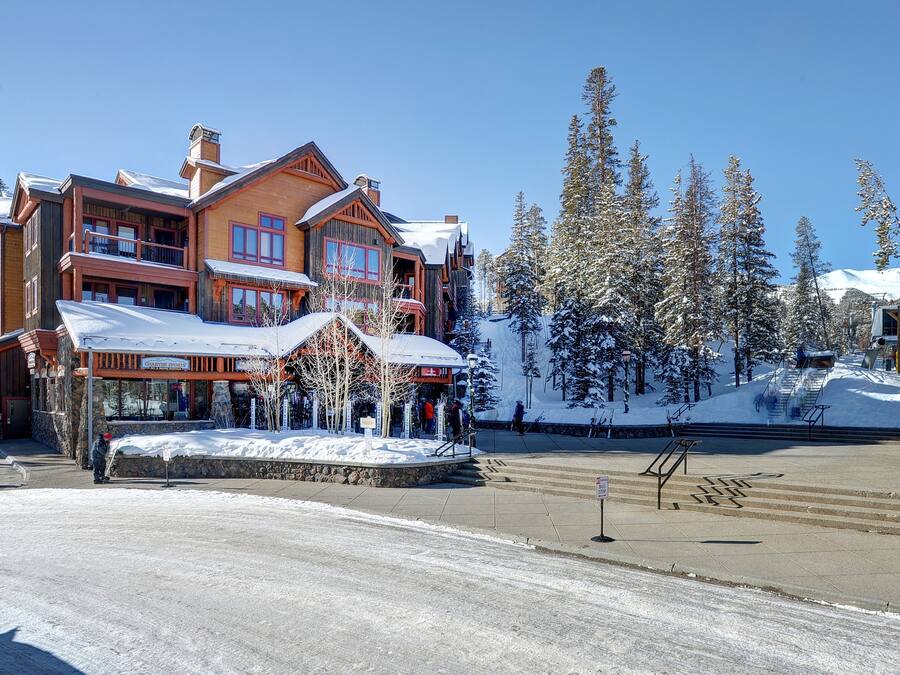 A large lodge with multiple balconies and a snow-covered landscape.